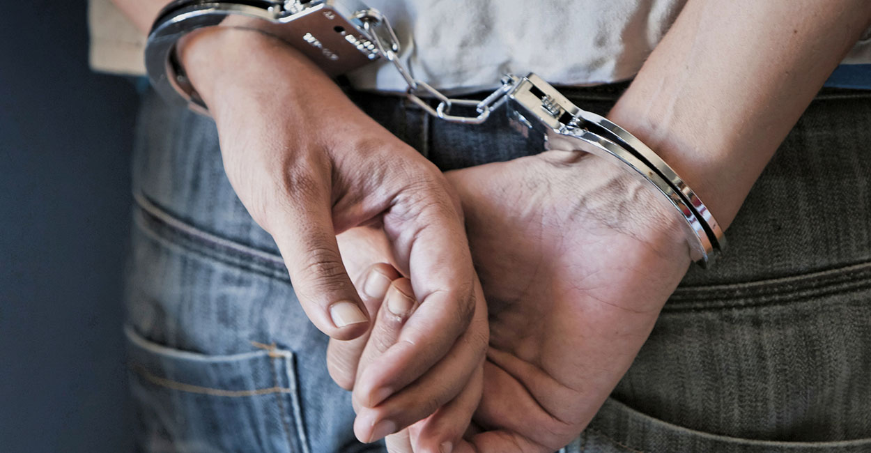 Young man in handcuffs