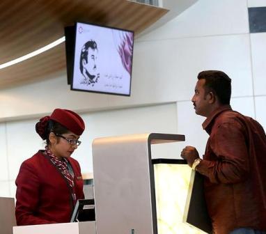 A passenger checks-in for a Qatar Airways flight at the Hamad International Airport in Doha on July 20, 2017. / AFP PHOTO / STRINGER (Photo credit should read STRINGER/AFP/Getty Images)