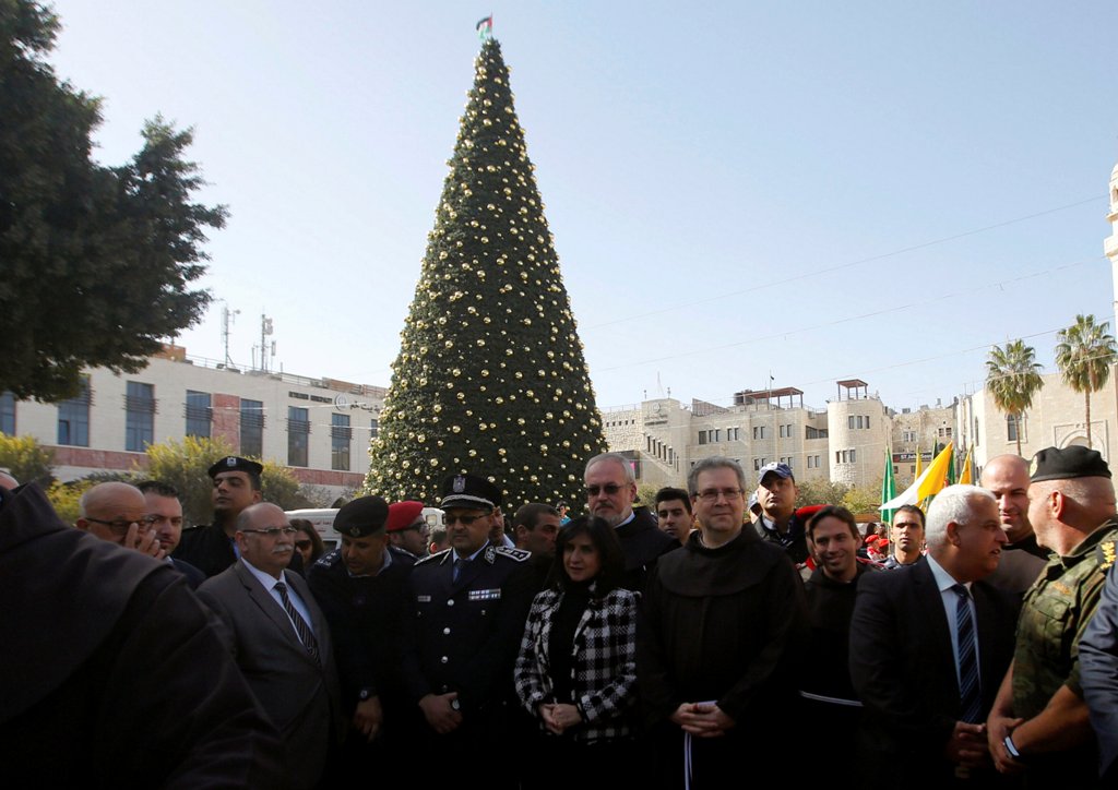 Custodian of the Holy Land Father Francesco Patton poses in front of a Christmas tree as he arrives to the Church of the Nativity to ceremonially launch the beginning of the Christmas season, in the West Bank city of Bethlehem November 26, 2016. REUTERS/Mussa Qawasma