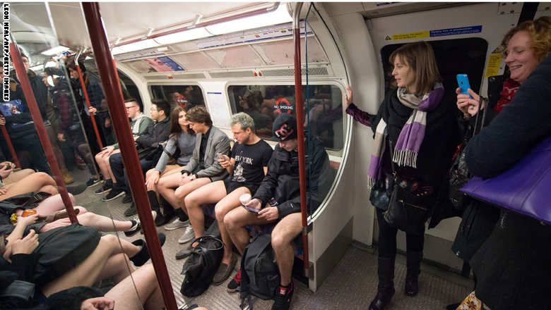 People take part in the annual "No Trousers On The Tube Day" event in central London on January 11, 2015. Originally started in the US, the international event, also known as the "No Pants Subway Ride" was created by improvisation group "Improv Everywhere" and sees people taking train journies while wearing no trousers, yet acting as normally as possible. AFP PHOTO / LEON NEAL (Photo credit should read LEON NEAL/AFP/Getty Images)