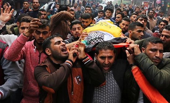 Palestinian mourners carry the body of Ismail Abu Riyala, a young Palestinian fisherman, during his funeral in Gaza City on March 15, 2018, two weeks after he was killed in a disputed incident. Israel argued his boat had strayed outside Gaza's designated fishing zone and fired upon it, but the Palestinian fishing union denied this. Photo by Ashraf Amra