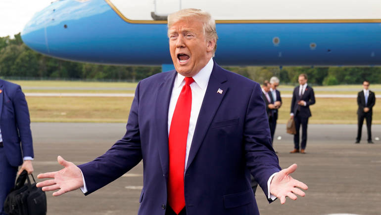 U.S. President Donald Trump reacts to the crowd on the tarmac as he walks from Air Force One after arriving at Ocala International Airport in Ocala, Florida, U.S., October 3, 2019. REUTERS/Kevin Lamarque