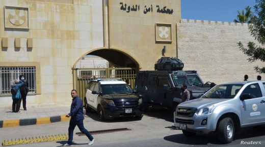 People walk outside a military court where the trial of former royal court chief Bassem Awadallah and a minor royal, Sherif Hassan Zaid, is set to take place in Amman, Jordan June 21, 2021. REUTERS/Muath Freij