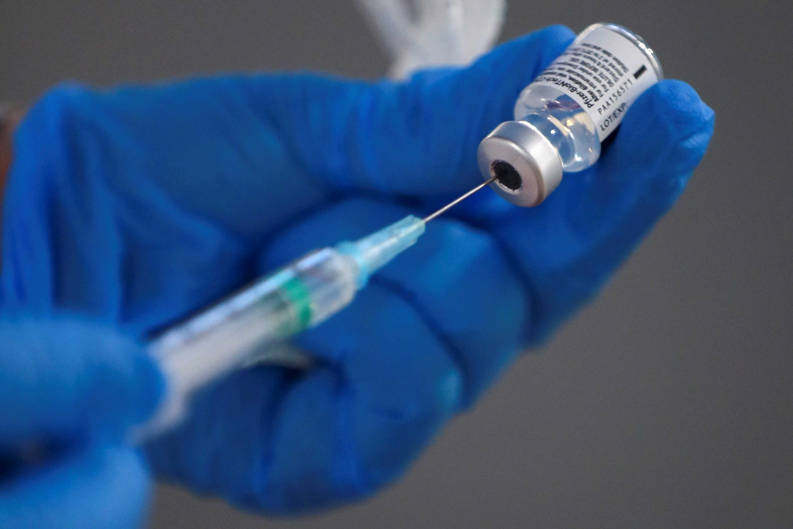 FILE PHOTO: A nurse fills a syringe with a second dose of the Pfizer-BioNTech COVID-19 vaccine, as the coronavirus disease (COVID-19) outbreak continues, at Enfermera Isabel Zendal new pandemic hospital in Madrid, Spain, February 4, 2021. REUTERS/Sergio Perez/File Photo