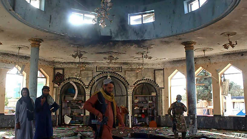 EDITORS NOTE: Graphic content / Taliban fighters investigate inside a Shiite mosque after a suicide bomb attack in Kunduz on October 8, 2021. (Photo by - / AFP)