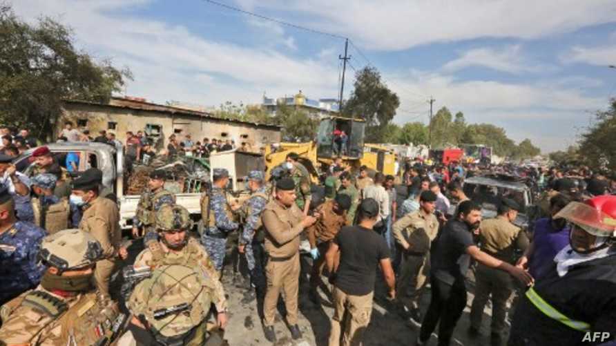 Members of the Iraqi army and security forces gather at the scene of an explosion in the Habibiya district of the Sadr City suburb of Iraq's capital Baghdad on April 15, 2021. - At least one civilian was killed in an explosion in the densely populated Shiite stronghold of Sadr City in eastern Baghdad, the Iraqi army reported, without determining the cause or the perpetrators. (Photo by Sabah ARAR / AFP)