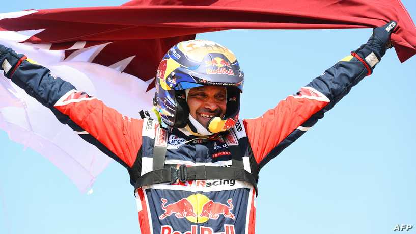 Toyota's driver Nasser Al-Attiyah of Qatar celebrates his victory after winning the Dakar Rally 2022, at the end of the last stage between Bisha and Jeddah in Saudi Arabia, on January 14, 2022. (Photo by FRANCK FIFE / AFP)