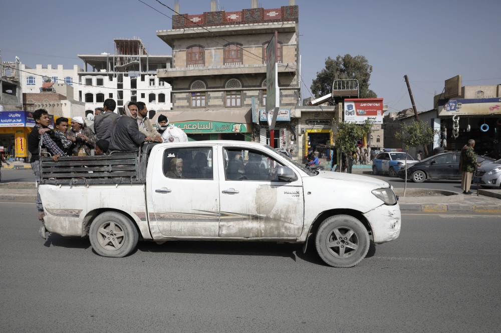 epa09863809 Yemenis ride on the back of a taxi pick-up truck at a street in Sana'a, Yemen, 29 March 2022 (issued 01 April 2022). The World Bank has approved an additional 300 million US dollar for desperately needed aid for over nine million Yemenis of extremely poor households in the war-ridden country as the United Nations estimates that nearly 1.6 million Yemenis are likely to fall into emergency levels of hunger in 2022 after aid agencies suspended vital relief programs in the impoverished country as of January 2022 due to severe funding shortfalls. EPA/YAHYA ARHAB