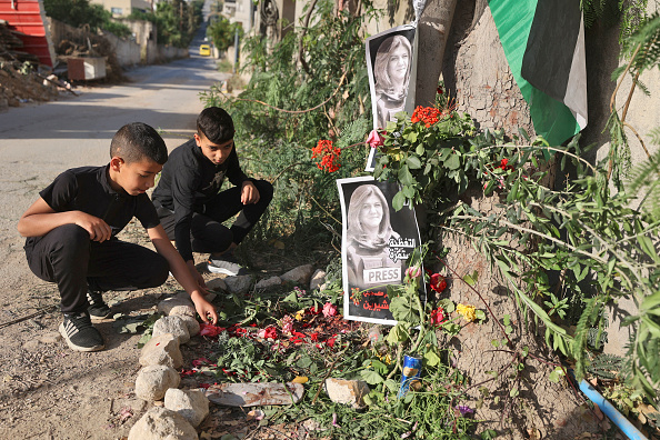 EDITORS NOTE: Graphic content / Children visit the site where veteran Al-Jazeera Palestinian journalist Shireen Abu Akleh was shot dead while covering an Israeli army raid in the occupied West Bank, in Jenin on May 12, 2022. - Al-Jazeera said Abu Aqleh, 51, a prominent figure in the channel's Arabic news service was shot dead by Israeli troops early on May 11, 2022 as she covered a raid on Jenin refugee camp in the occupied West Bank. Israeli Prime Minister Naftali Bennett said it was "likely" that Palestinian gunfire killed her. (Photo by JAAFAR ASHTIYEH / AFP) (Photo by JAAFAR ASHTIYEH/AFP via Getty Images)