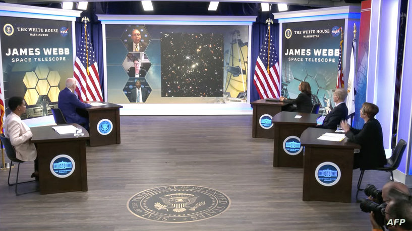 In this still picture from a NASA TV broadcast, US President Joe Biden (L) and UV Vice President Kamala Harris preview the first infrared images from the James Webb Space Telescope (JWST) during a briefing from National Aeronautics and Space Administration (NASA) officials in the South Court Auditorium at the White House in Washington, DC, on July 11, 2022. - NASA's James Webb Space Telescope is poised to reveal some of the earliest galaxies that formed after the Big Bang, the White House said Monday, as anticipation builds for the powerful observatory's first images.
President Joe Biden will unveil the images during a livestreamed event starting at 5:00 pm (2100 GMT).
"The high resolution images will show light captured from galaxies that are more than 13 billion years old," White House spokeswoman Karine Jean-Pierre said. (Photo by NASA TV / AFP) / RESTRICTED TO EDITORIAL USE - MANDATORY CREDIT "AFP PHOTO / NASA TV" - NO MARKETING - NO ADVERTISING CAMPAIGNS - DISTRIBUTED AS A SERVICE TO CLIENTS