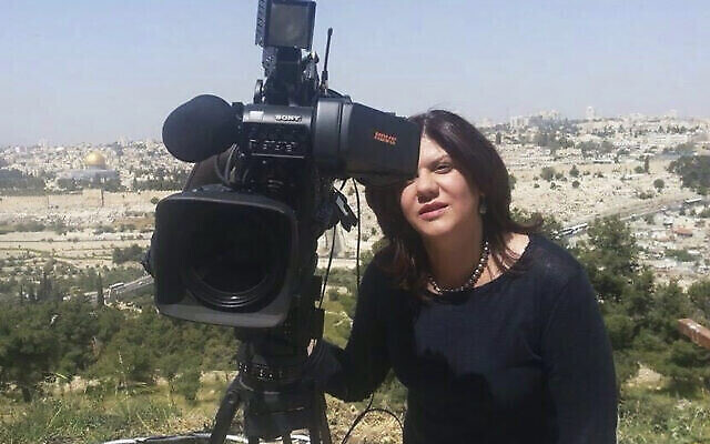 In this undated photo provided by Al Jazeera Media Network, Shireen Abu Akleh, a journalist for Al Jazeera network, stands next to a TV camera in an area where the Dome of the Rock shrine at Al-Aqsa Mosque in the Old City of Jerusalem is seen at left in the background. Abu Akleh, a well-known Palestinian female reporter for the broadcaster's Arabic language channel, was shot and killed while covering an Israeli raid in the occupied West Bank town of Jenin early Wednesday, May 11, 2022. (Al Jazeera Media Network via AP)